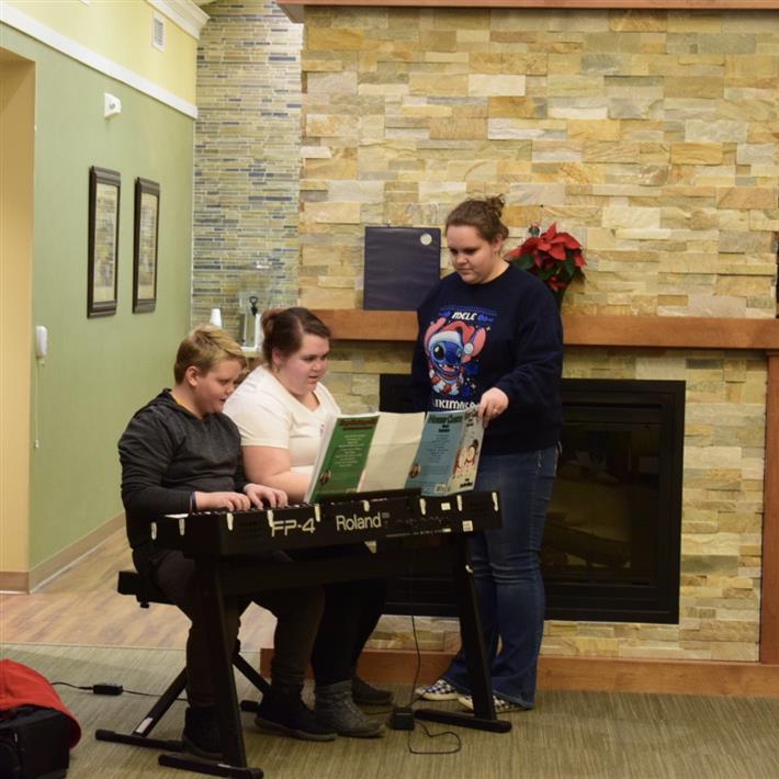 Gavin & Chrissy did a duet of I Saw Three Ship - - the music was too big for the stand so Angie came up to help!