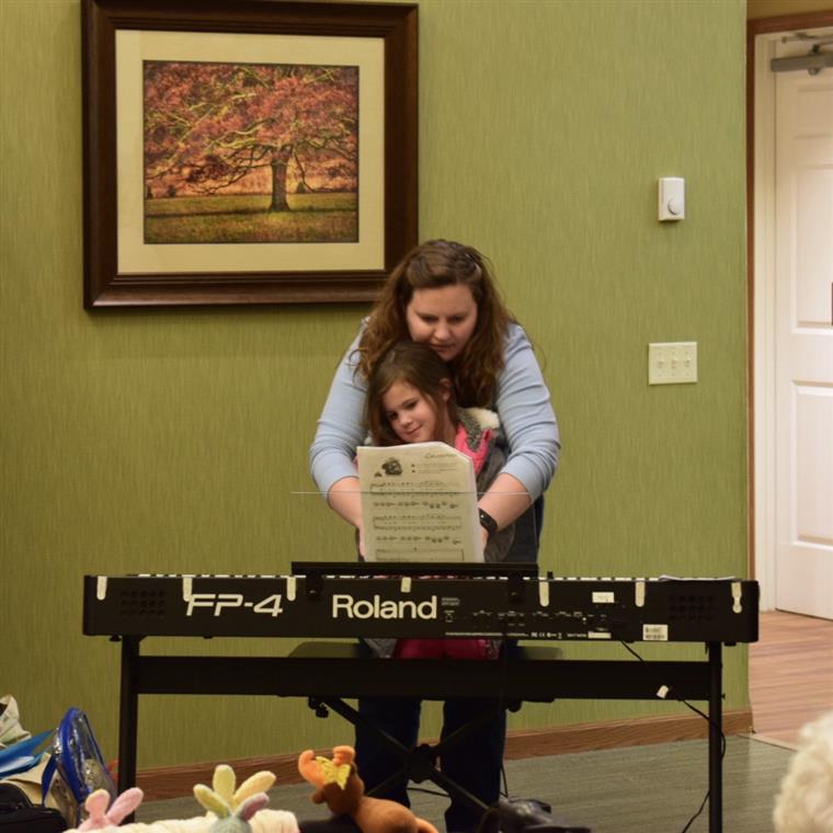 Emily needed some help from Mom getting started on Jolly Old St Nicholas on the piano.